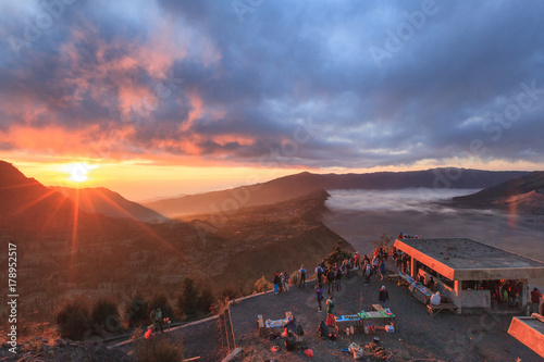 group of traveler at Bromo vocano looking fog in morning during sun rise photo