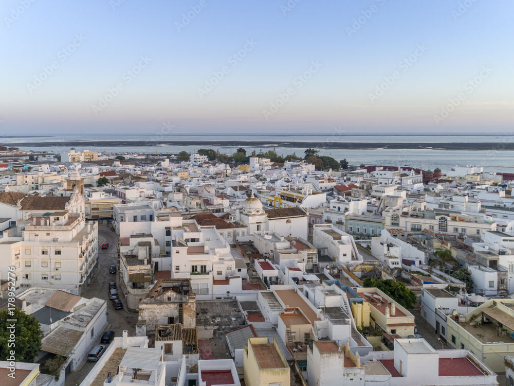 Sunset aerial cityscape in Olhao, Algarve fishing village view of ancient neighbourhoods of Barreta and Levante, and its traditional cubist architecture.