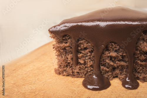 A piece of chocolate pie decorated with hot chocolate closeup photo