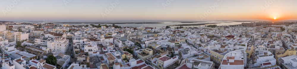 Sunset aerial cityscape in Olhao, Algarve fishing village view of ancient neighbourhoods of Barreta and Levante, and its traditional cubist architecture.