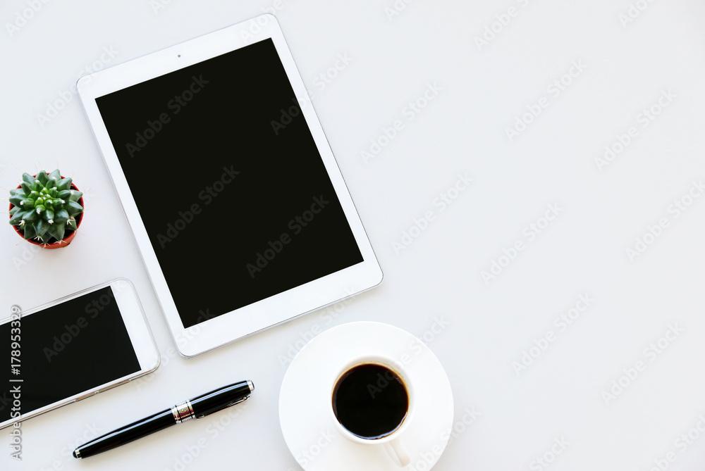 Office table with tablet,smartphone,pen,coffee cup and cactus, copy space,Top view, flat lay Office table with tablet,smartphone,pen,coffee cup and cactus, copy space,Top view, flat lay