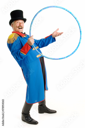 Ringmaster Circus Director, isolated on white background, senior man inviting people to jump through his hoop photo