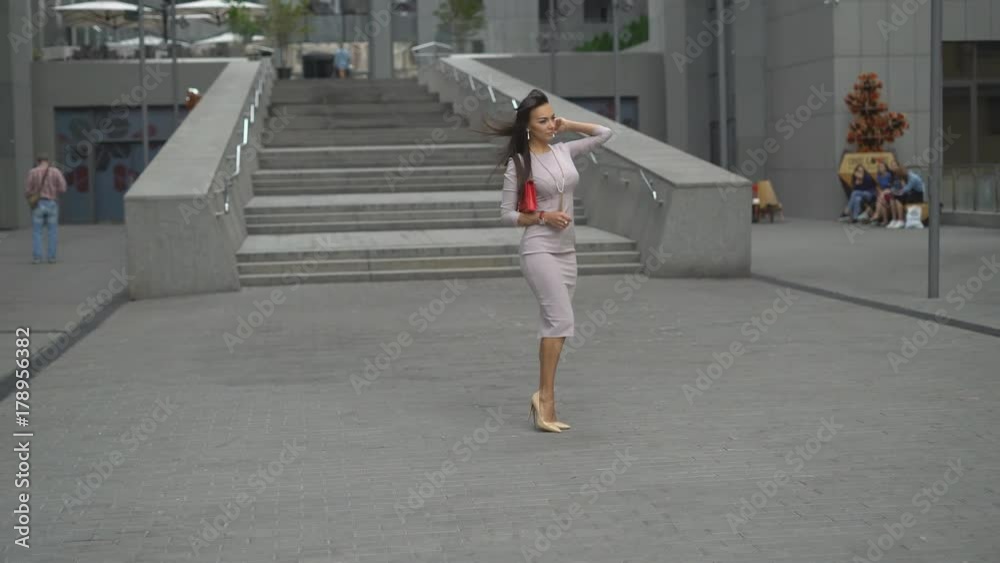 young attractive brunette woman in short pudding dress dancing on the steps in shoes on a high wraparound. photo shoot for photographer. 4k young attractive brunette woman in short pudding dress dancing on the steps in shoes on a high wraparound. photo shoot for photographer. 4k