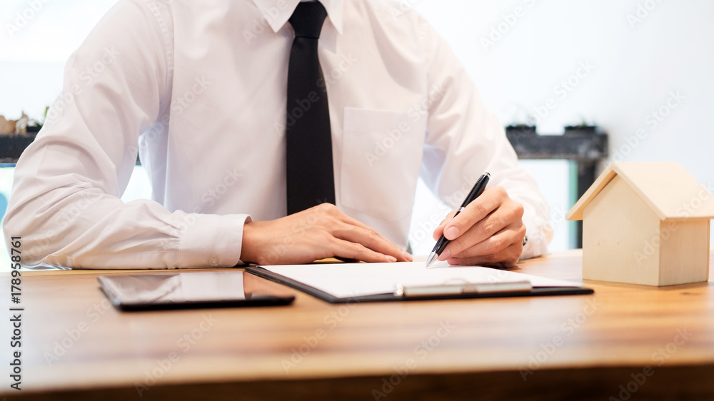 customer signing contract, agreed terms and approved application and analyzing valuation home loan, meeting with bank worker or real estate agent. customer signing contract, agreed terms and approved application and analyzing valuation home loan, meeting with bank worker or real estate agent.