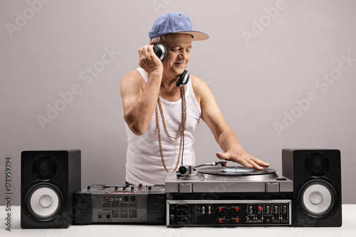 Mature man playing music on a turntable