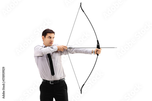 Businessman aiming with a bow and arrow