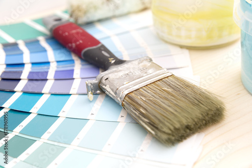 Fototapeta Naklejka Na Ścianę i Meble -  Color palette guide and painting supplies, paint brushes and color cans on wooden background