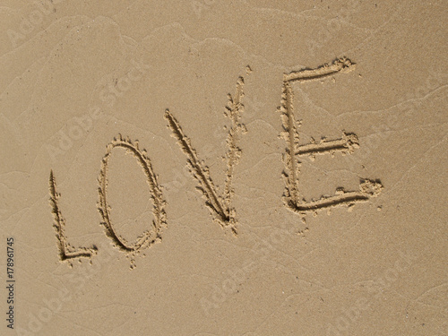  LOVE  inscription on a sandy beach © vodolej