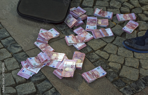 A businessman scattered the euro banknotes on the ground