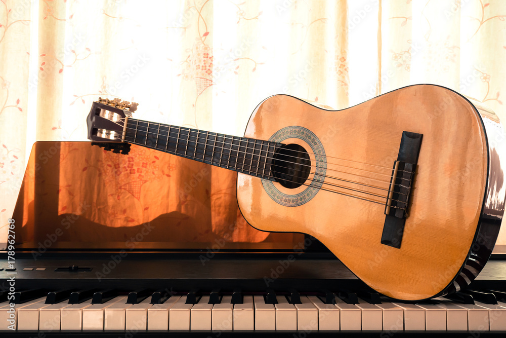 Guitar on piano keyboard. Classical music instrument. Sepia and warm color  tone. Art and music background. Stock Photo | Adobe Stock