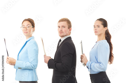 Portrait of three office workers standing one after another on white background