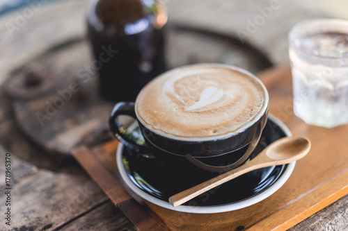 Coffee cup and coffee beans on wood table ,warm and good smell