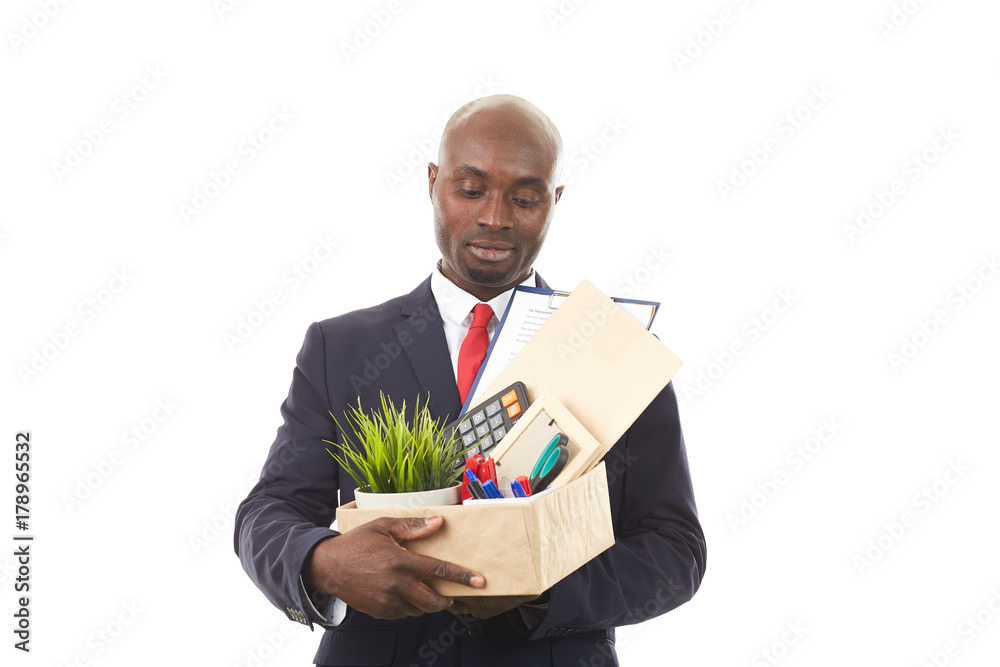 Portrait of African office worker holding box with personal belongings