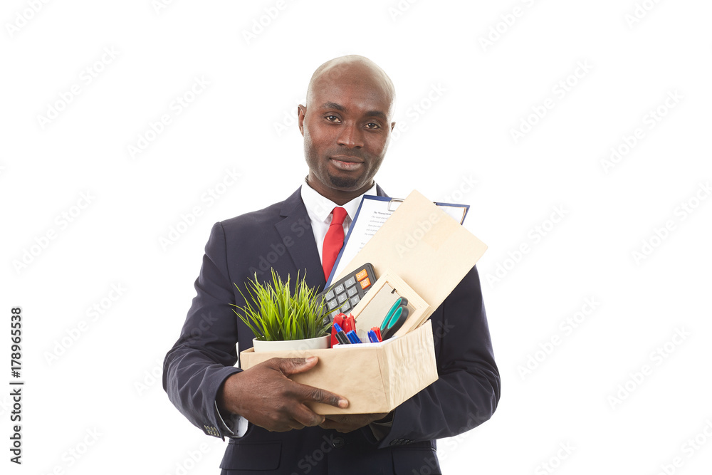 Portrait of African office worker holding box with personal belongings Portrait of African office worker holding box with personal belongings