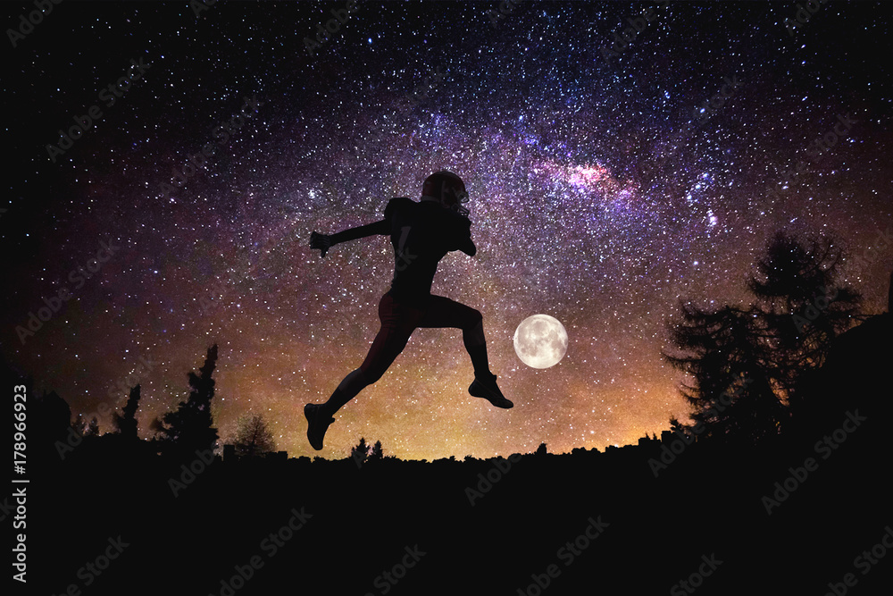 player football man jumping at the night starry sky background. Mixed media