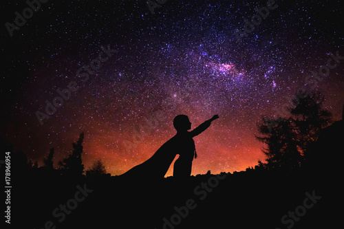 superhero at the night starry sky background. Mixed media