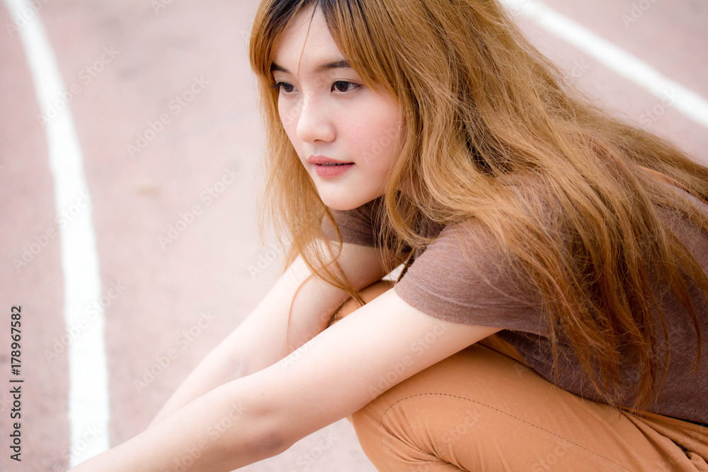 Beautiful young adult thai chinese bronze hair relax and smile Beautiful young adult thai chinese bronze hair relax and smile