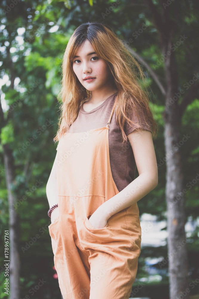 Beautiful young adult thai chinese bronze hair relax and smile Beautiful young adult thai chinese bronze hair relax and smile
