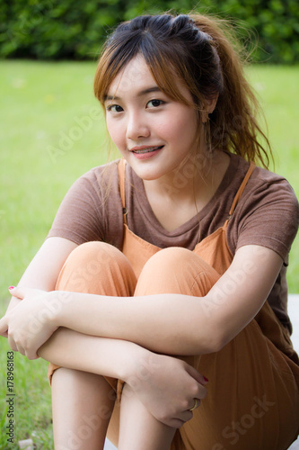 Beautiful young adult thai chinese bronze hair relax and smile