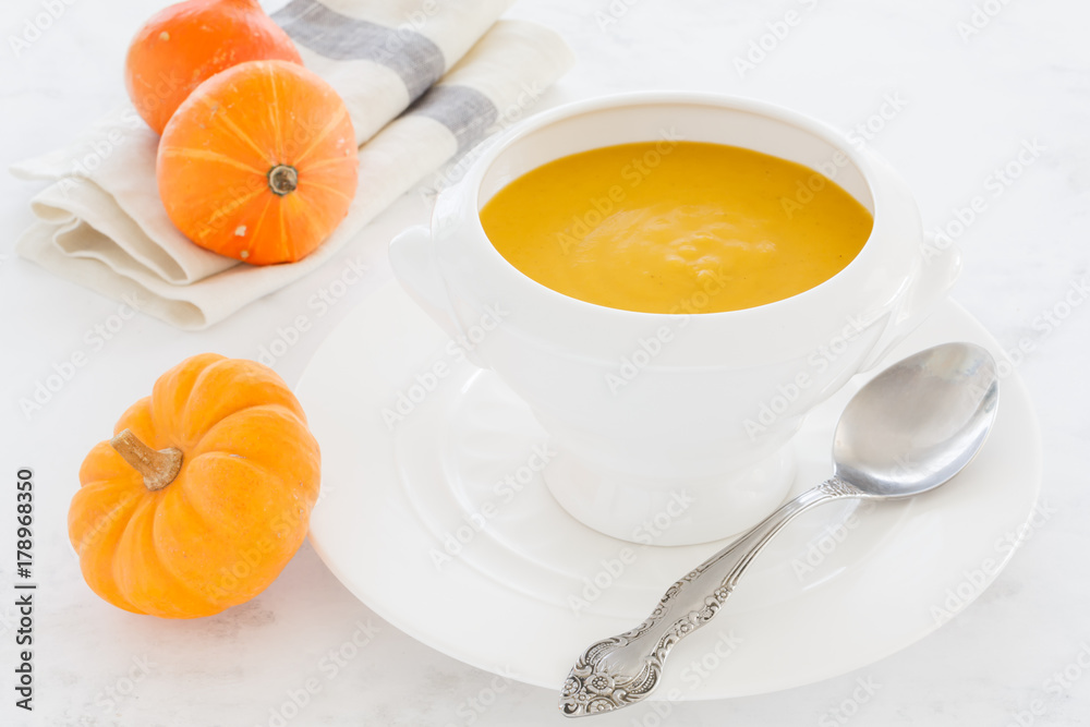vegetable orange soup with parmesan cheese, bacon, mushrooms in a white deep soup plate. soup macro vegetable orange soup with parmesan cheese, bacon, mushrooms in a white deep soup plate. soup macro