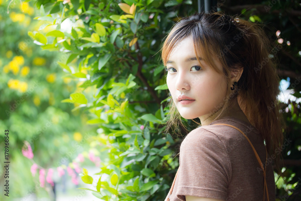 Beautiful young adult thai chinese bronze hair relax and smile Beautiful young adult thai chinese bronze hair relax and smile