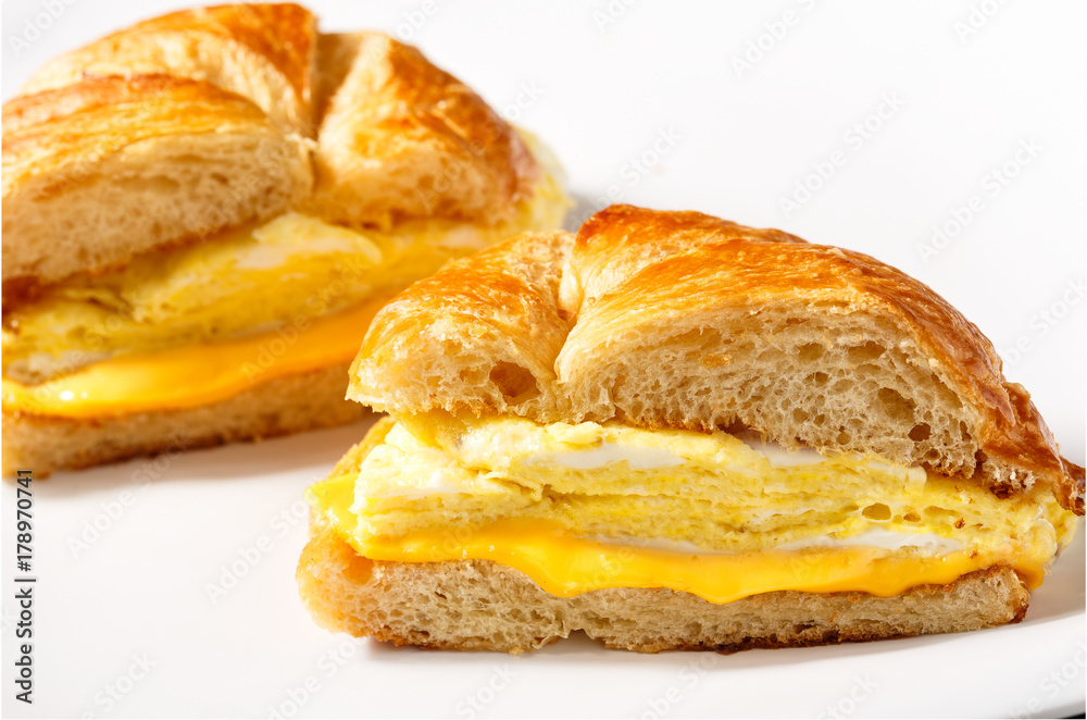 Breakfast Croissant with Egg and Cheese on a White Background with copy space
