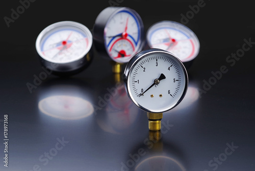 Manometer in focus. A pressure gauge on the background of other instruments.