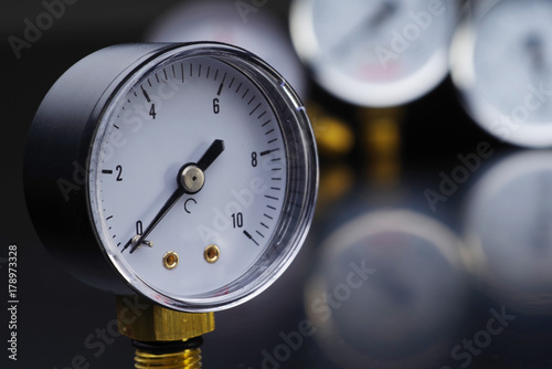 Manometer in focus. A pressure gauge on the background of other instruments.