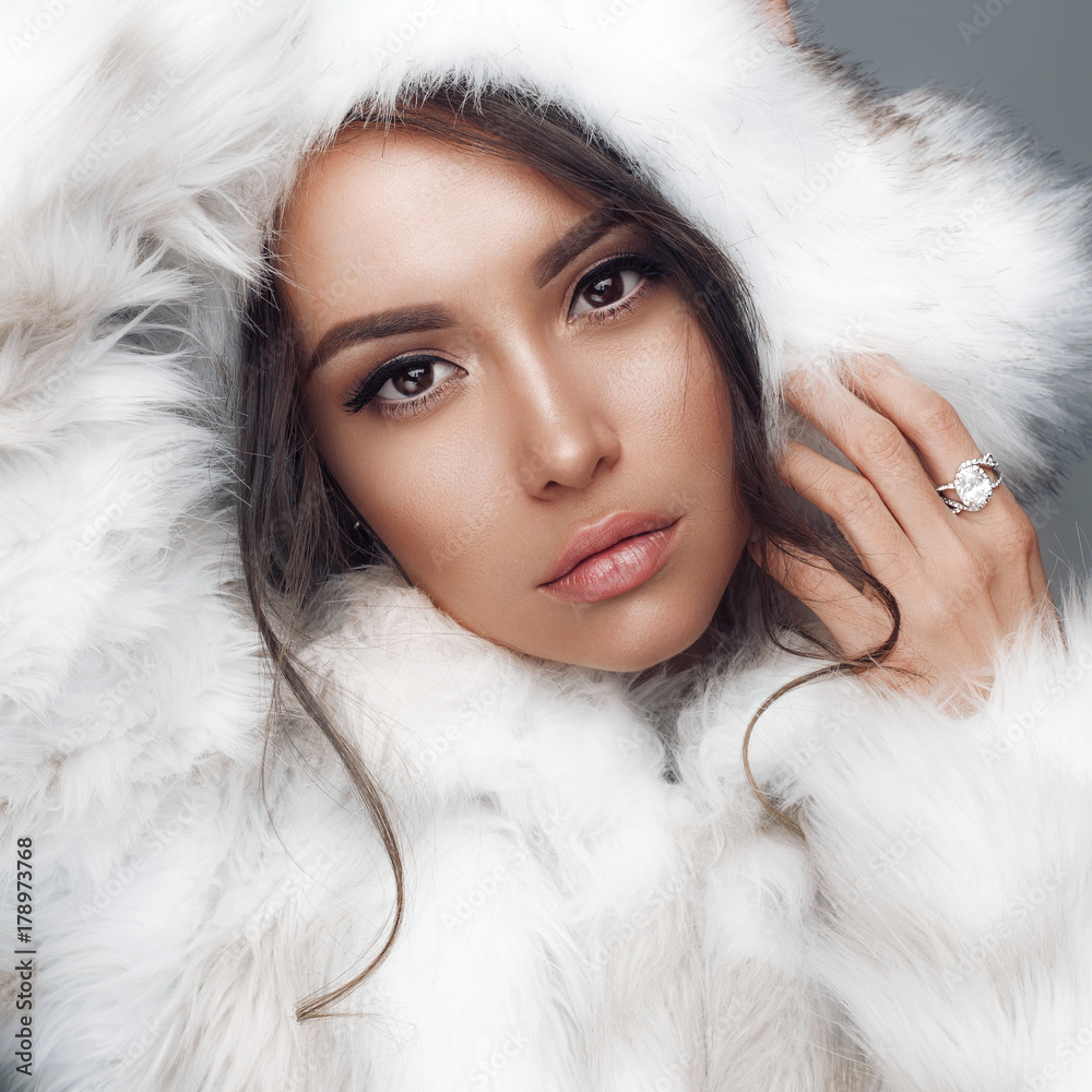 Beautiful woman in white fur coat and fur hat Stock Photo | Adobe Stock