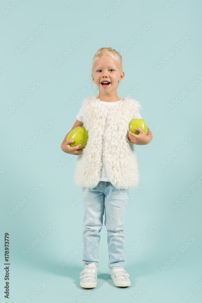 Pretty, cute girl in light clothes hold apples Pretty, cute girl in light clothes hold apples