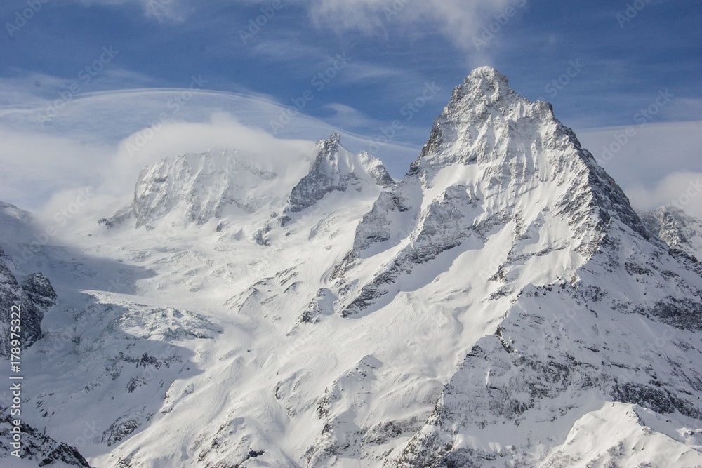 Winter mountains and peaks on a clear day. Winter mountains and peaks on a clear day.