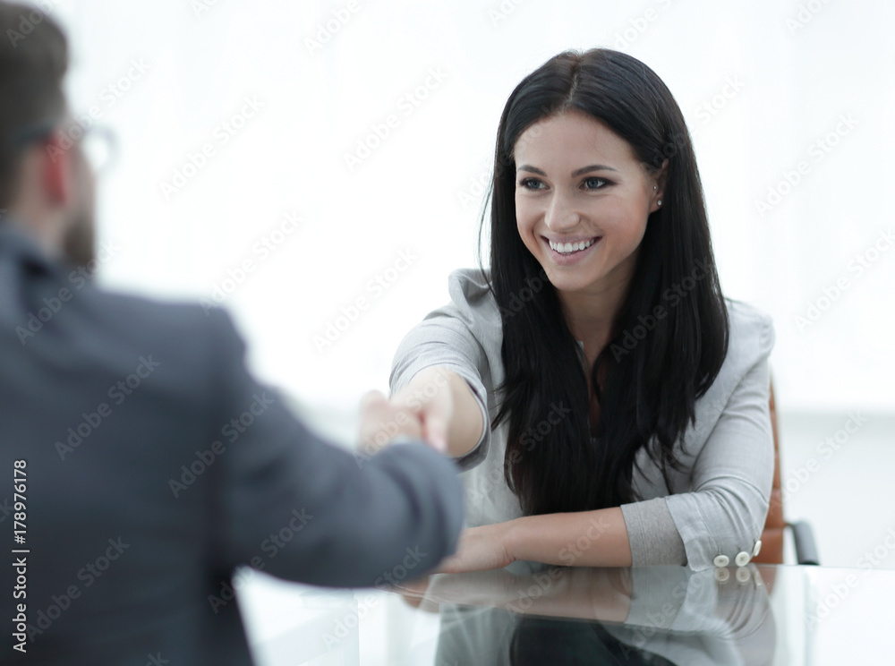 handshake young business woman with a partner in the office handshake young business woman with a partner in the office