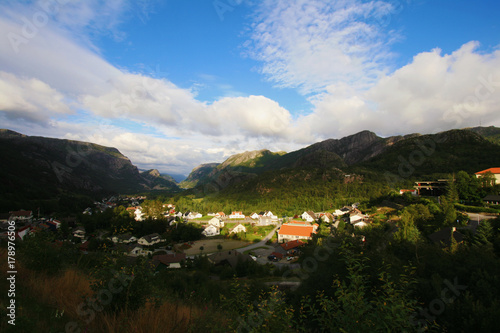 A sunlit Norwegian village situated in a valley