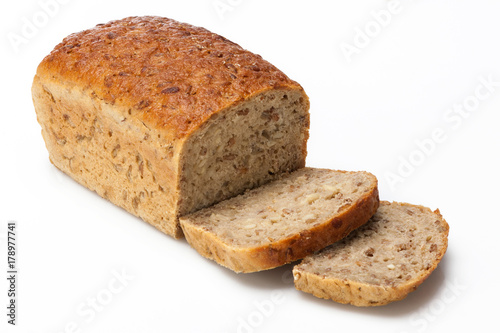 Partially sliced bread on a white background