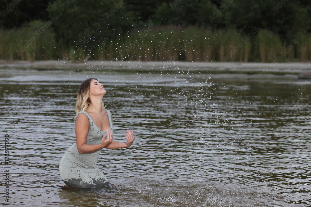 Fototapeta premium sexy girl in the water in a dress
