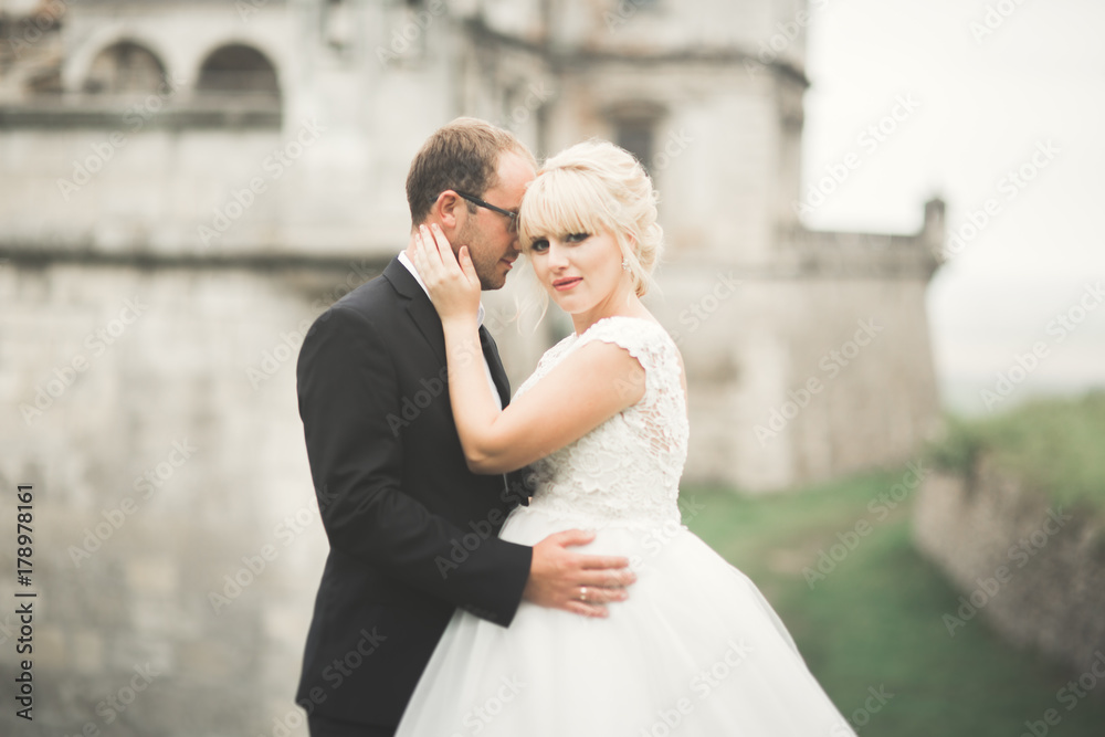 Sensual married couple, valentines hugging in front of old slavic castle Sensual married couple, valentines hugging in front of old slavic castle