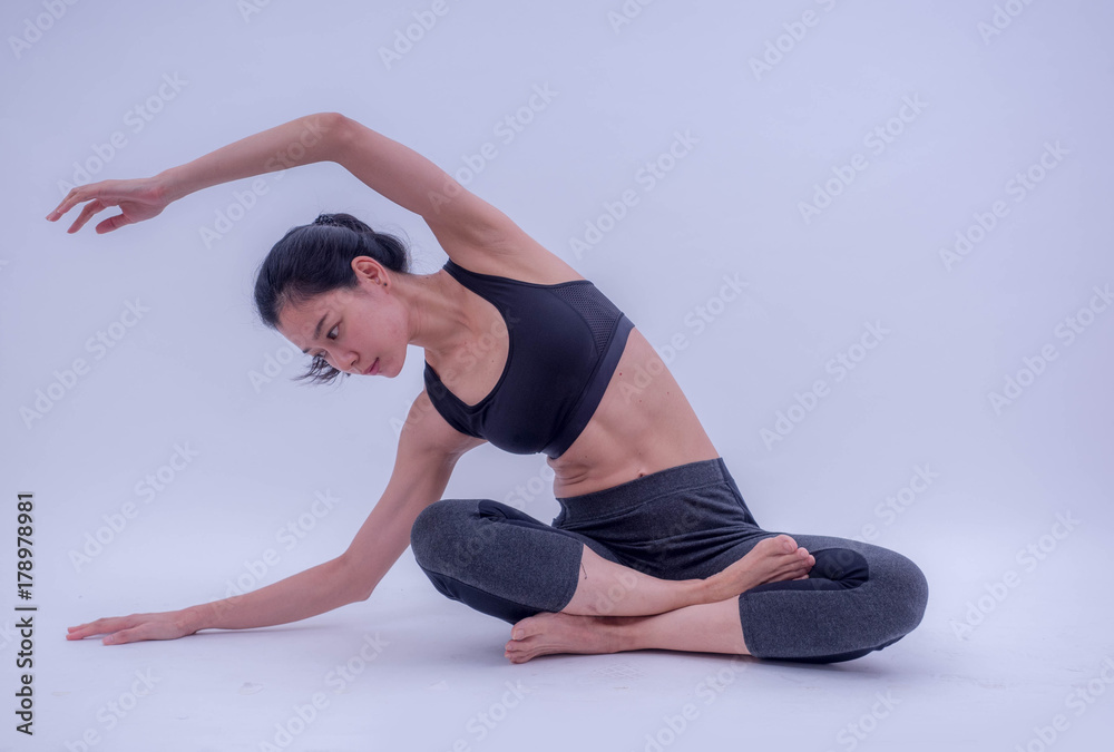 Beautiful young Asian doing yoga exercise isolated on white background. Healthy lifestyle and good wellness concepts
