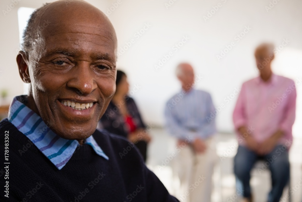 Close up Portrait of smiling senior man with friends in Close up Portrait of smiling senior man with friends in