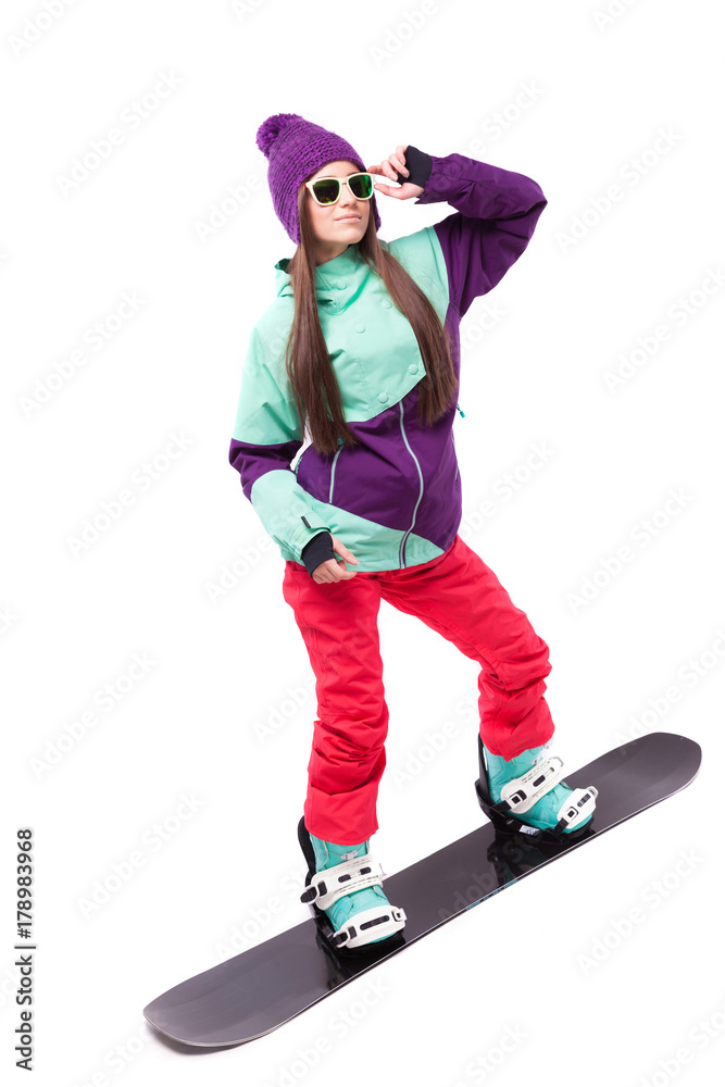 pretty young brunette woman in purple ski costume rides black snowboard pretty young brunette woman in purple ski costume rides black snowboard