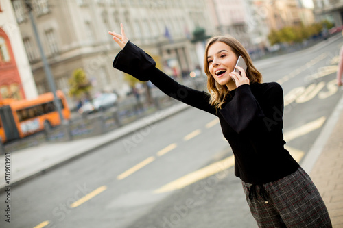 Young woman waiting for tax...