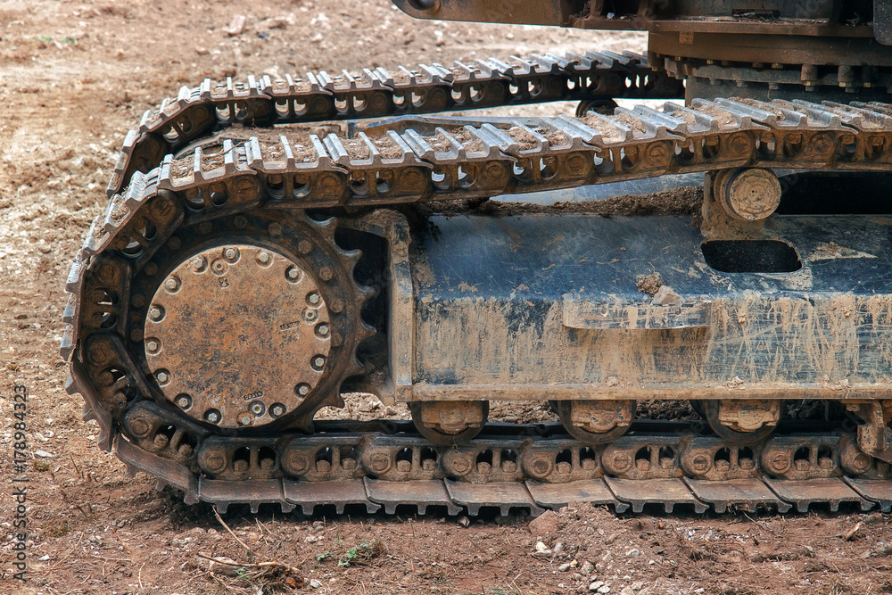 excavator wheels on mud, detail of dirty machine on mud 