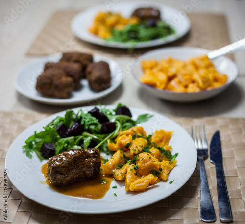 Carrot noodles, beef roulades and salad with beets and rocket salad