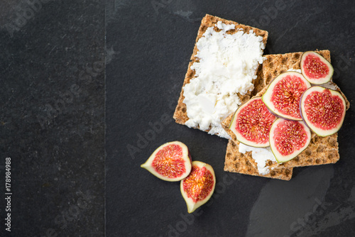 Healthy snack from wholegrain rye crispbread crackers, figs and ricotta cheese