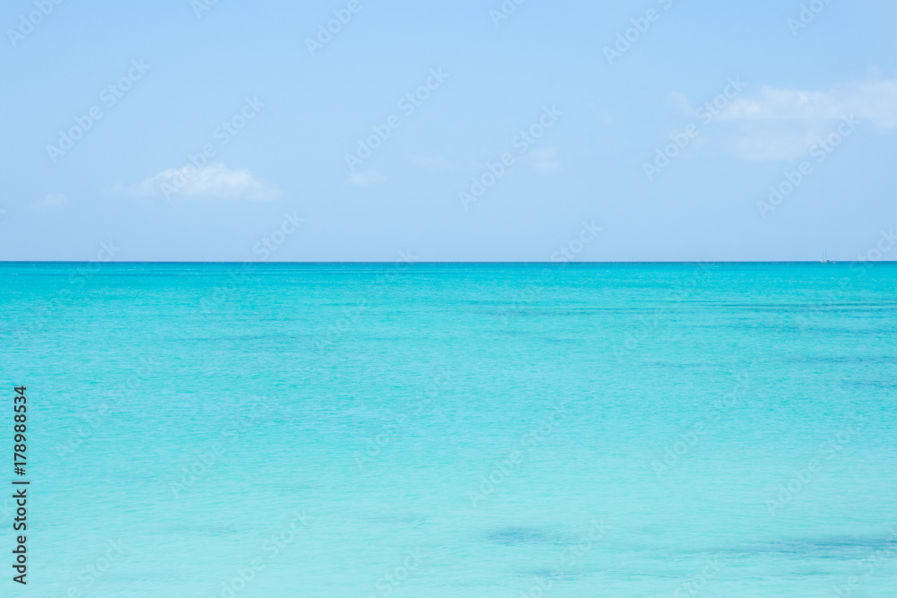 A perfect horizon line between turquoise sea water and blue sky. Caribbean, Turks and Caicos Islands. 