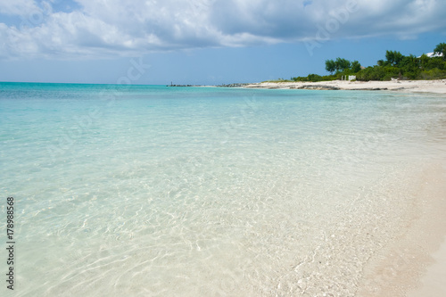 Turquoise sea water with white sand beach and blue sky. Turks and Caicos Islands. © ShyLama Productions