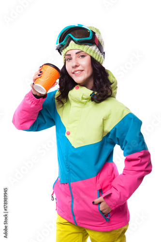 beautiful young woman in ski outfit and ski goggles blue snow boots
