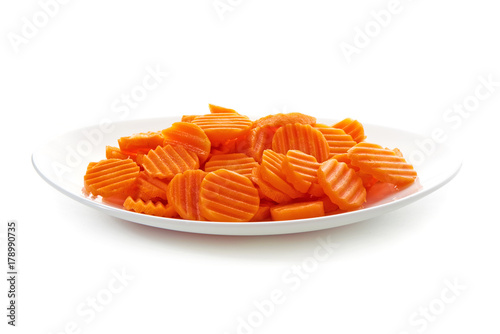 Sliced carrot on white plate, isolated on white background