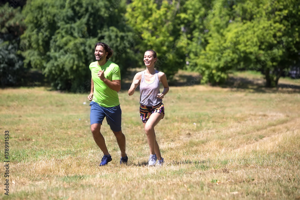 Healthy, fit and  sportive couple running in park