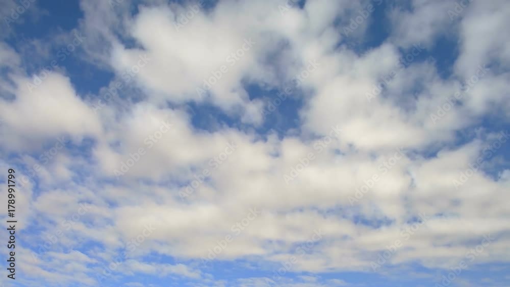 Fluffy clouds moving from right to left in the blue sky Fluffy clouds moving from right to left in the blue sky