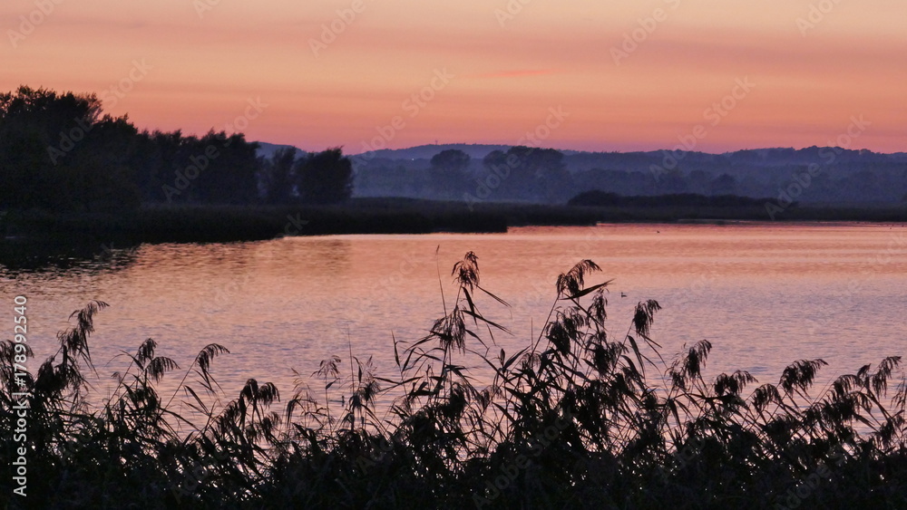 Naklejka premium Dramatic sunset at a lake in Schleswig-Holstein, Germany
